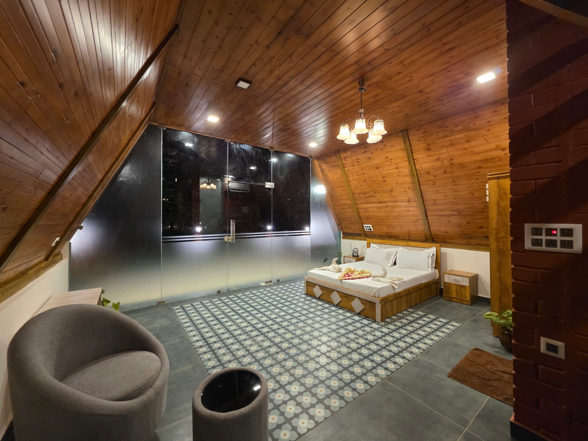 A-Frame cottage interior with glass wall opening to the plantation
