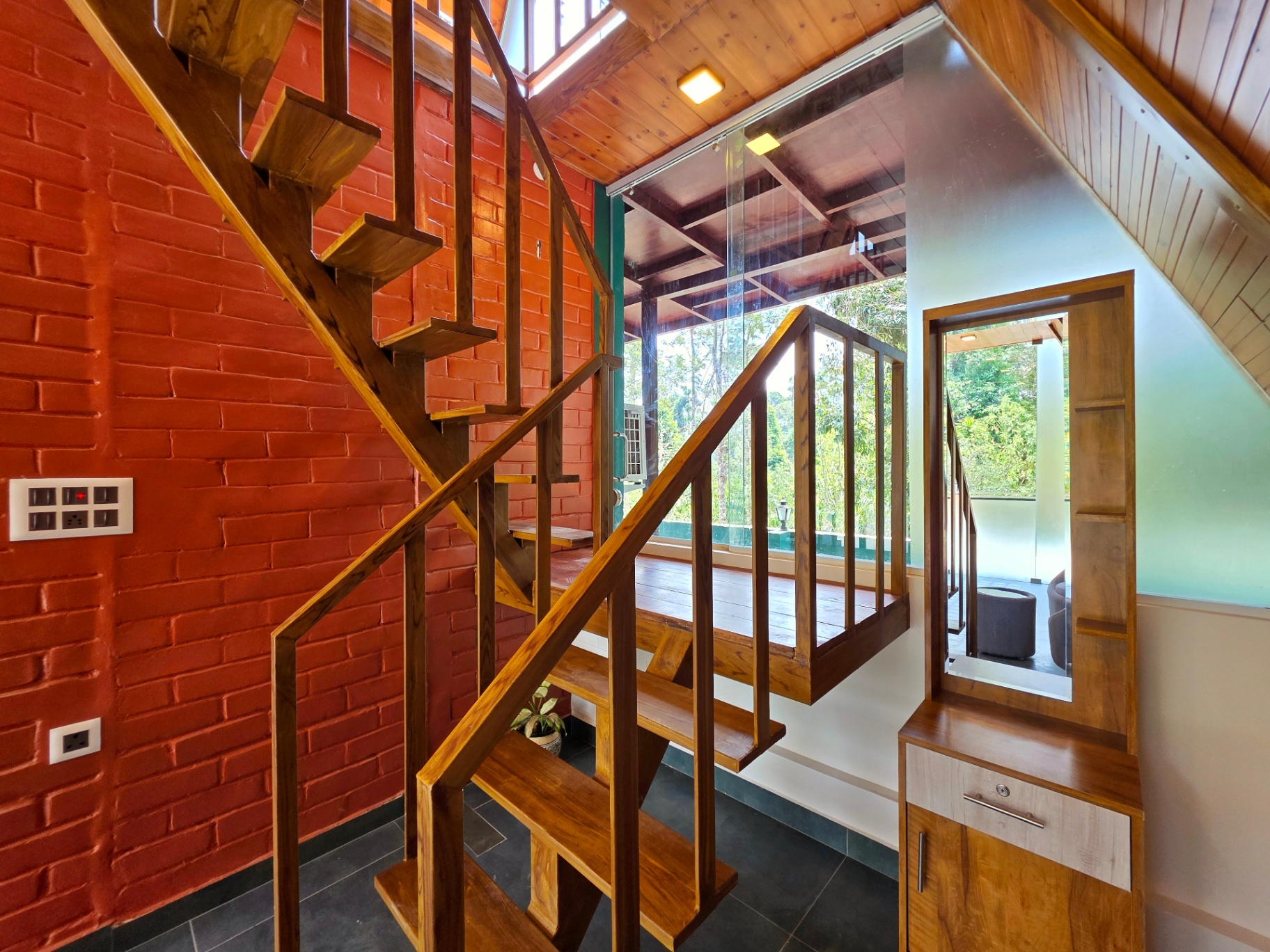 A-frame cottage wooden staircase against exposed brick wall