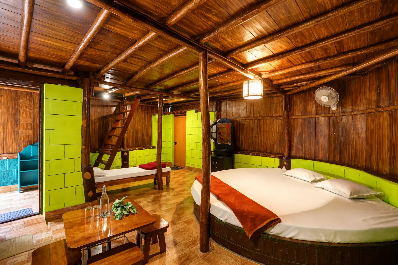 Cottage attic sleeping loft with bamboo roof and colourful blankets