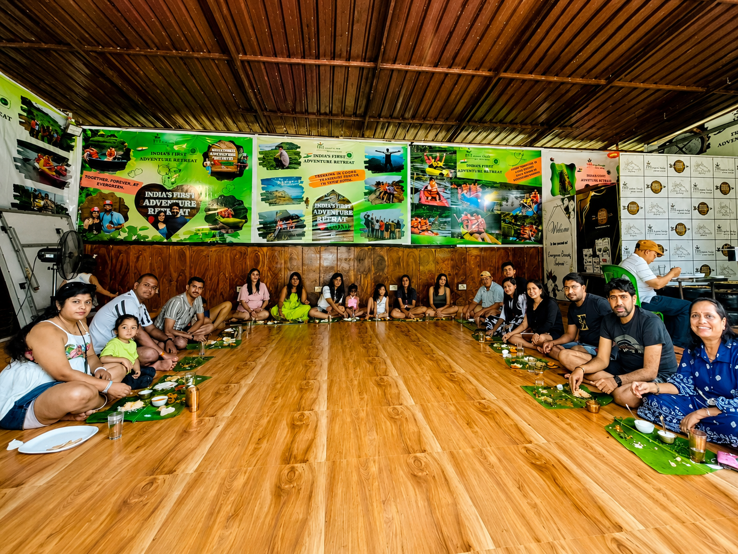Guests dining together on fresh banana leaves at Evergreen County