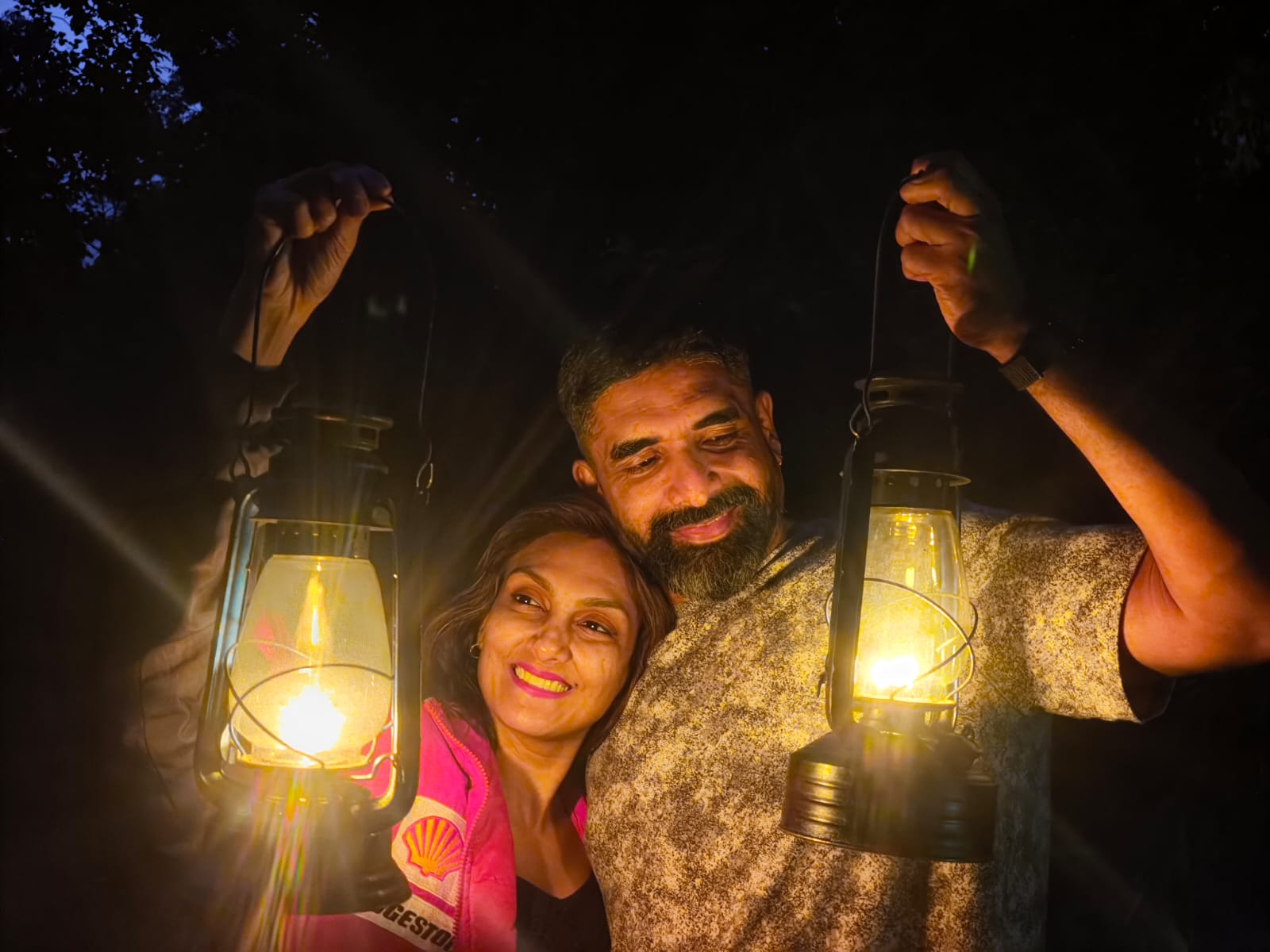 Couple with lanterns on a night plantation walk