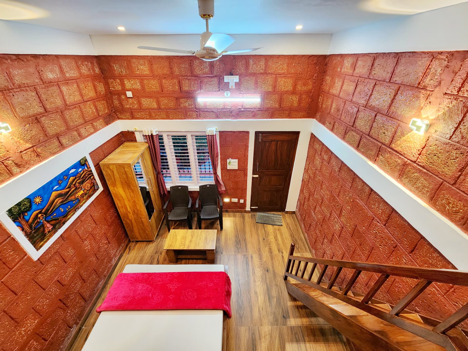 Stone Age Room seating area viewed from the loft with wooden staircase