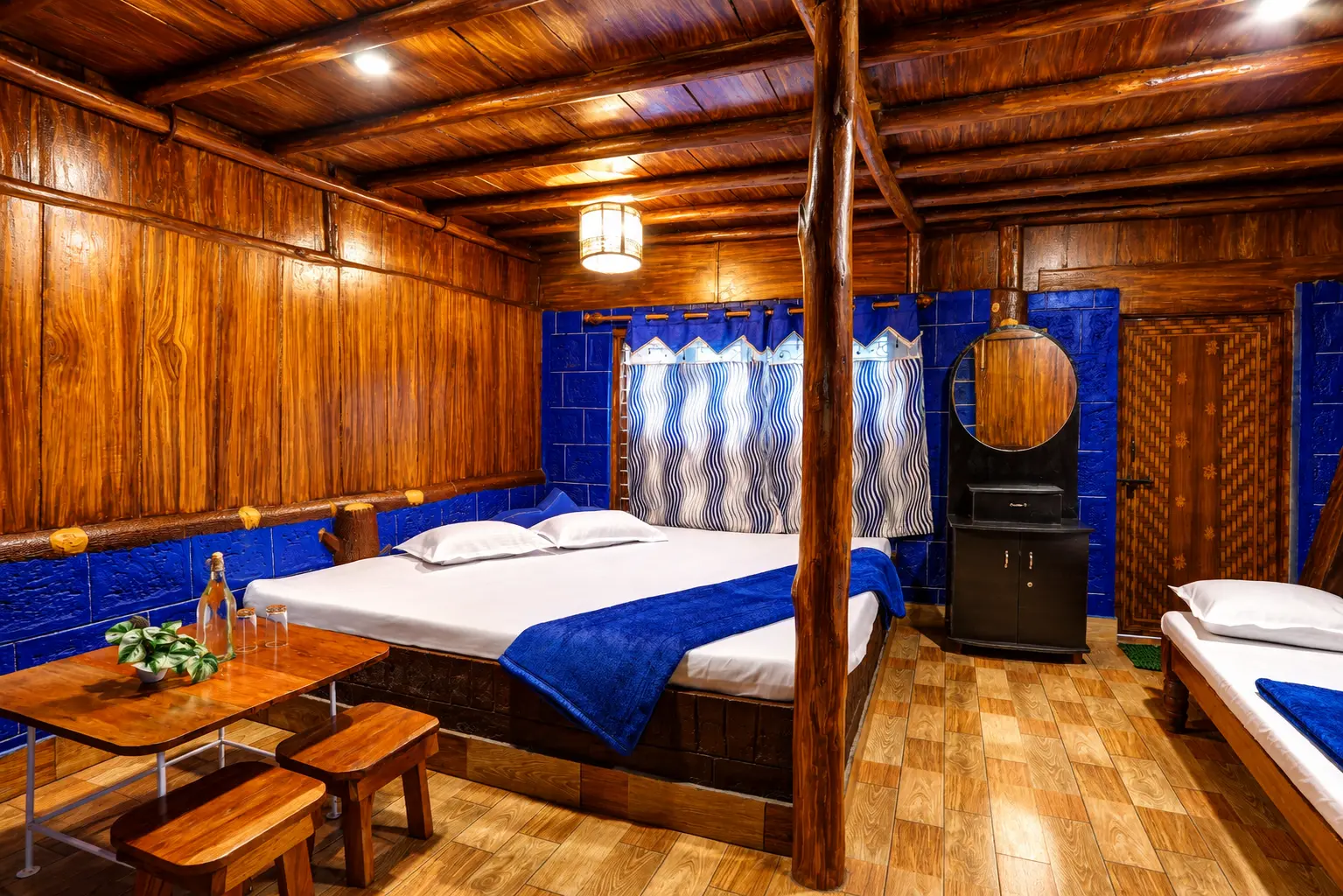 Blue-themed rustic wooden cottage bedroom with king bed at Seven Heaven Cottages