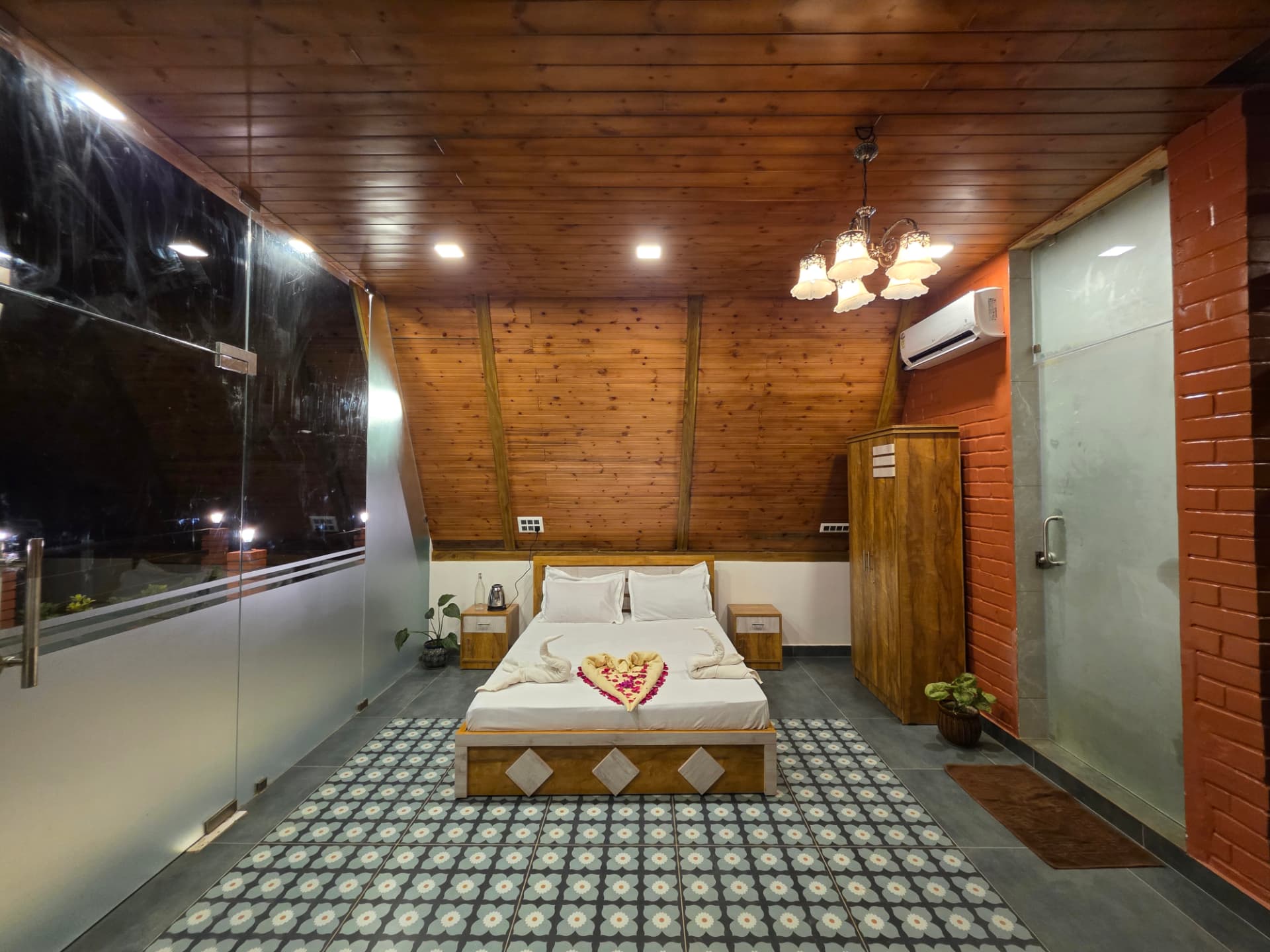 A-Frame cottage bedroom with balcony glass and rose petal turndown