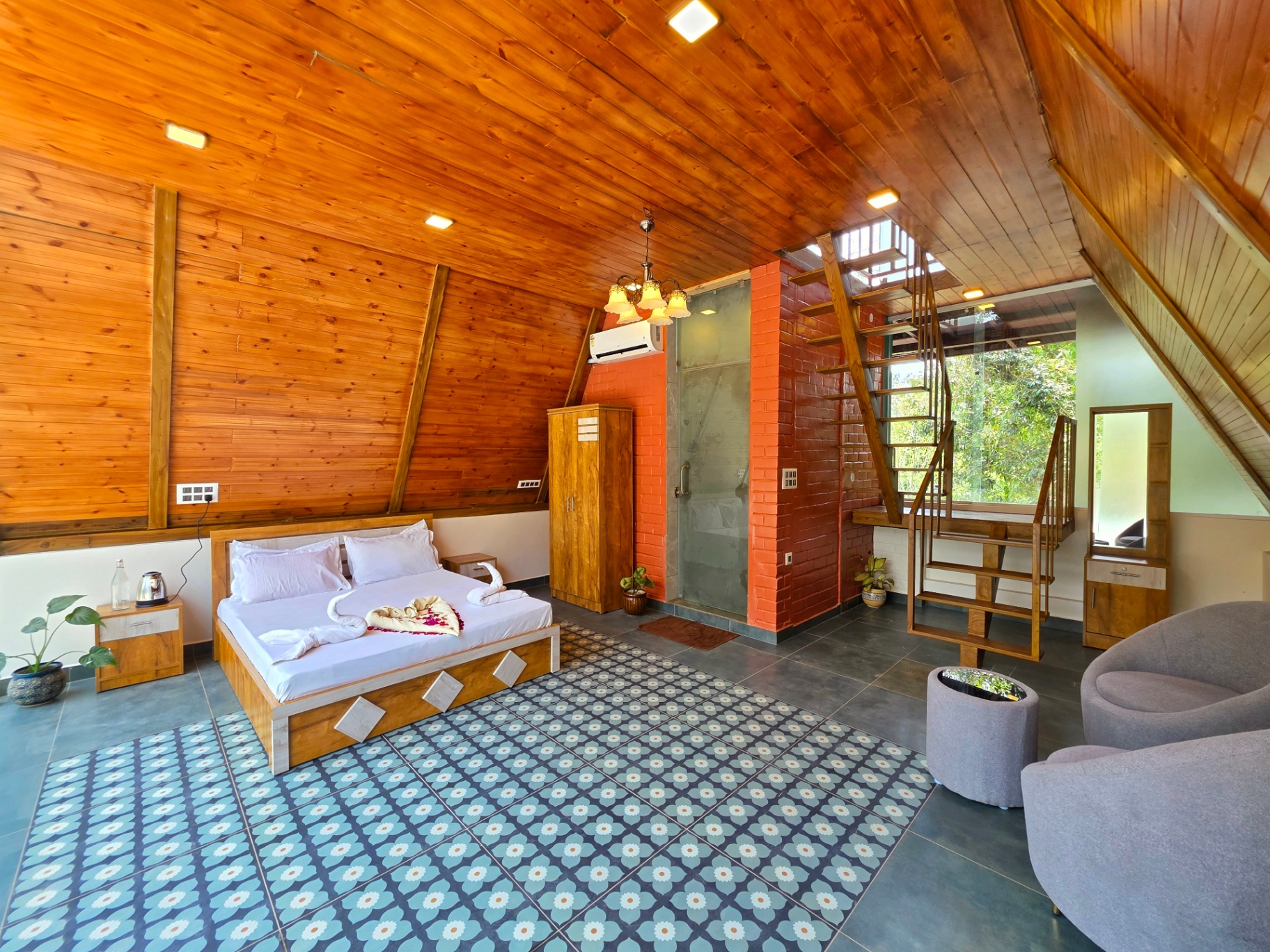 A-frame cottage main bedroom with wooden ceiling and patterned tile floor