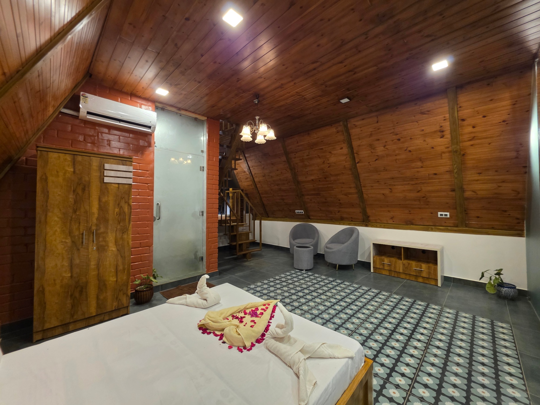 A-frame cottage lounge area with seating and wardrobe